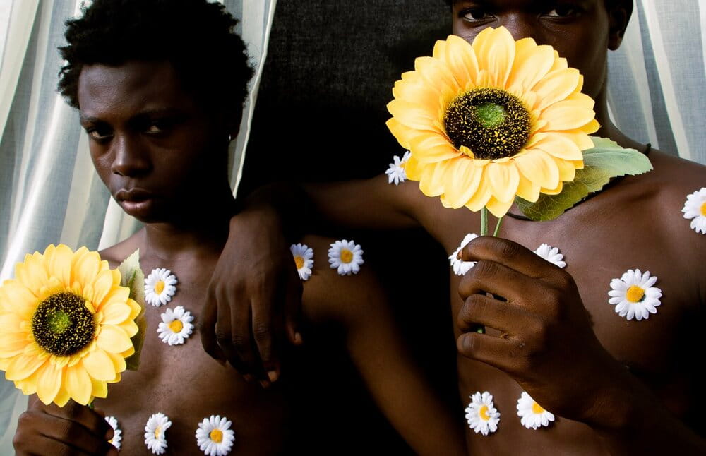 Hands holding seaweed in shallow water